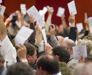 Leute die durch Zettel erheben abstimmen